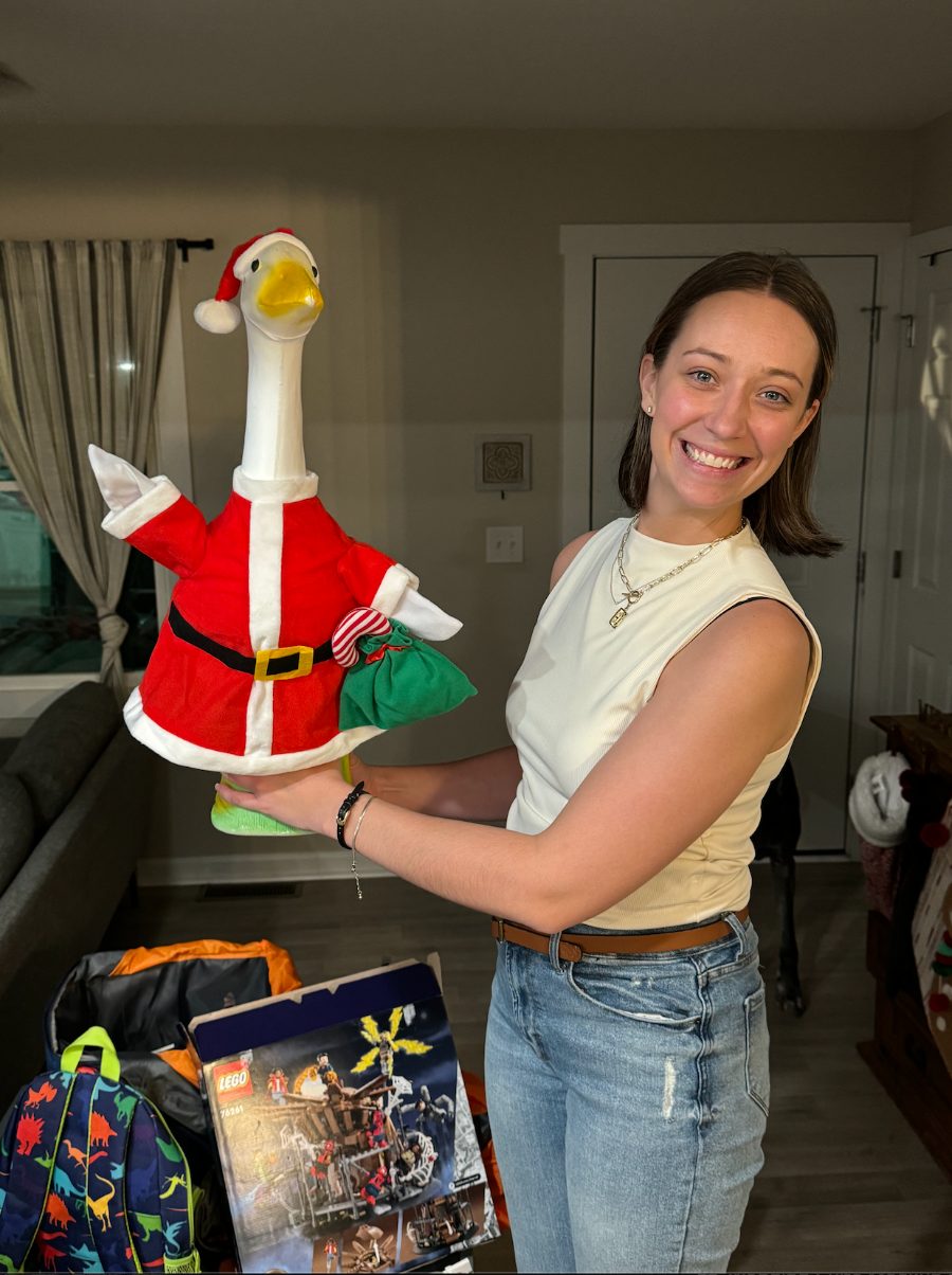 Holding a goose statue dressed as Santa
